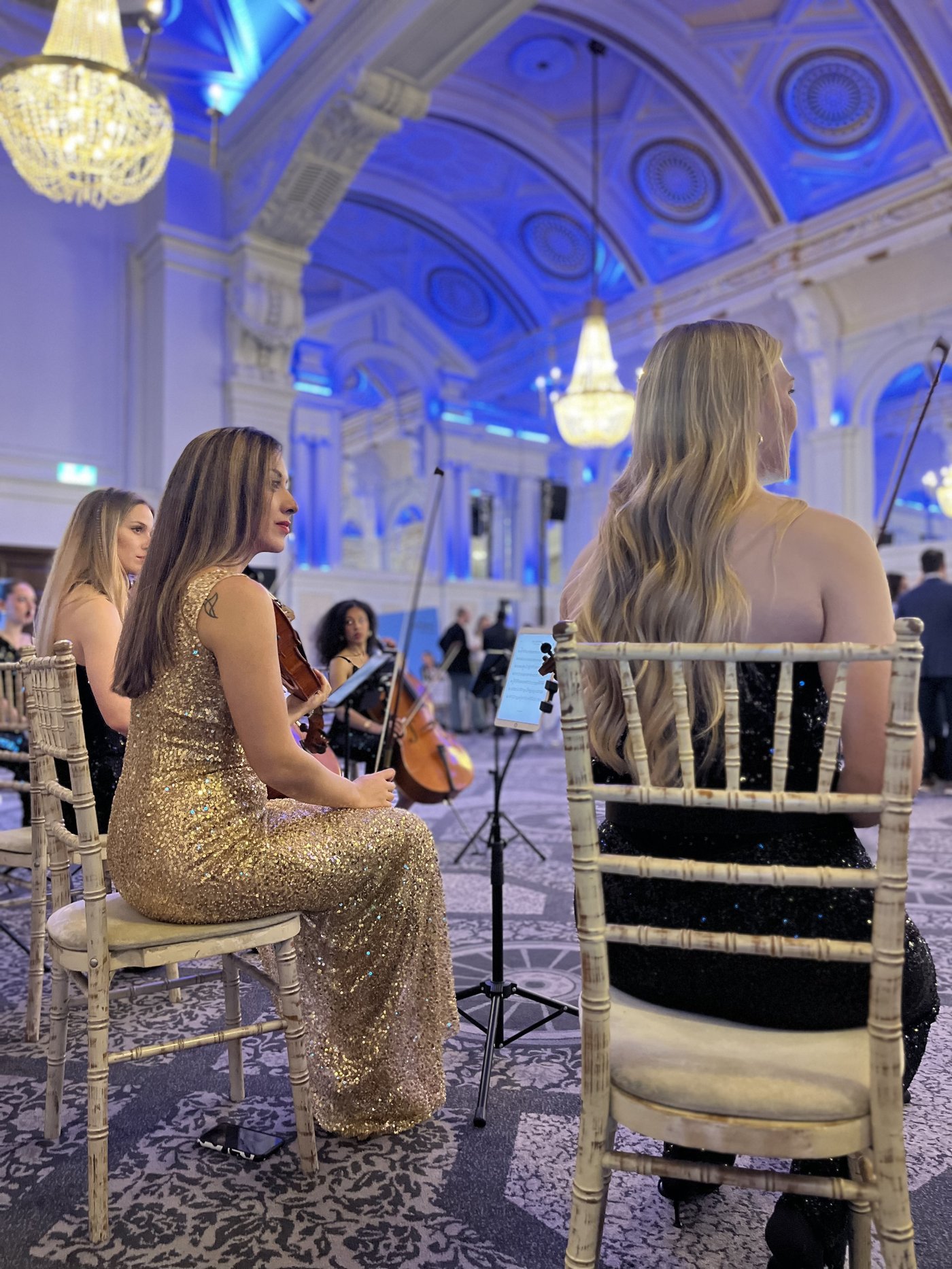 Secret Strings string players performing in a grand ballroom — London session musicians